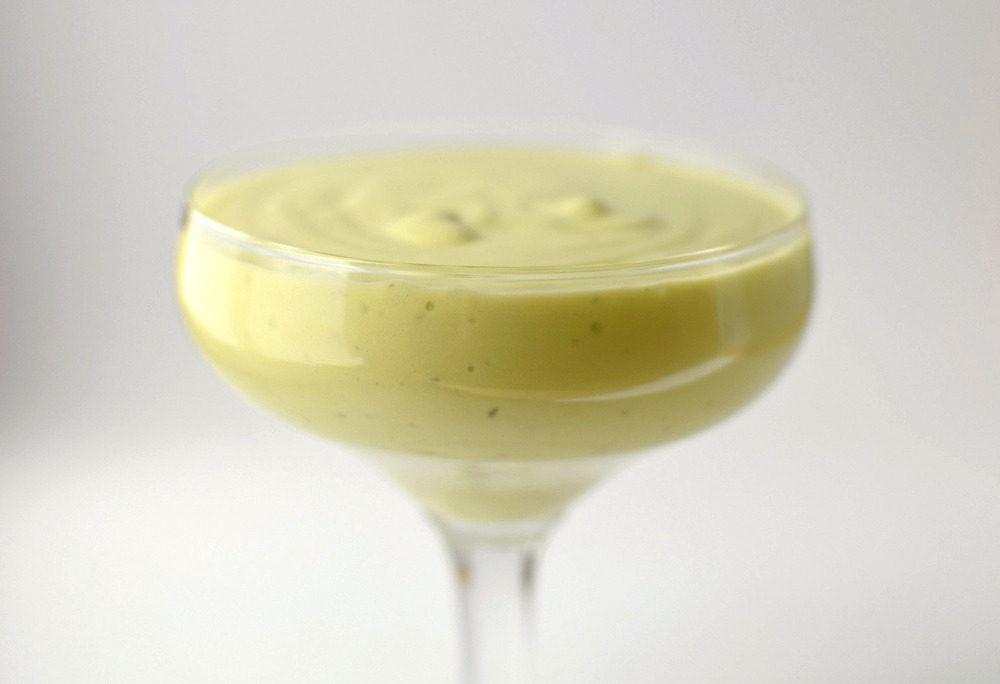 A glass filled with avocado ice cream base