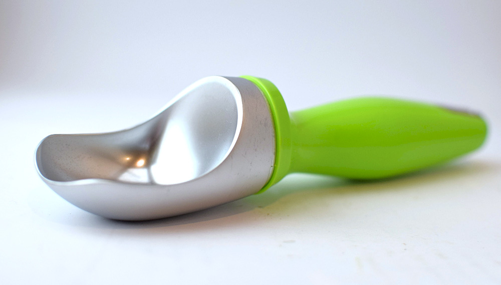 A Zyliss ice cream scoop laying on the table