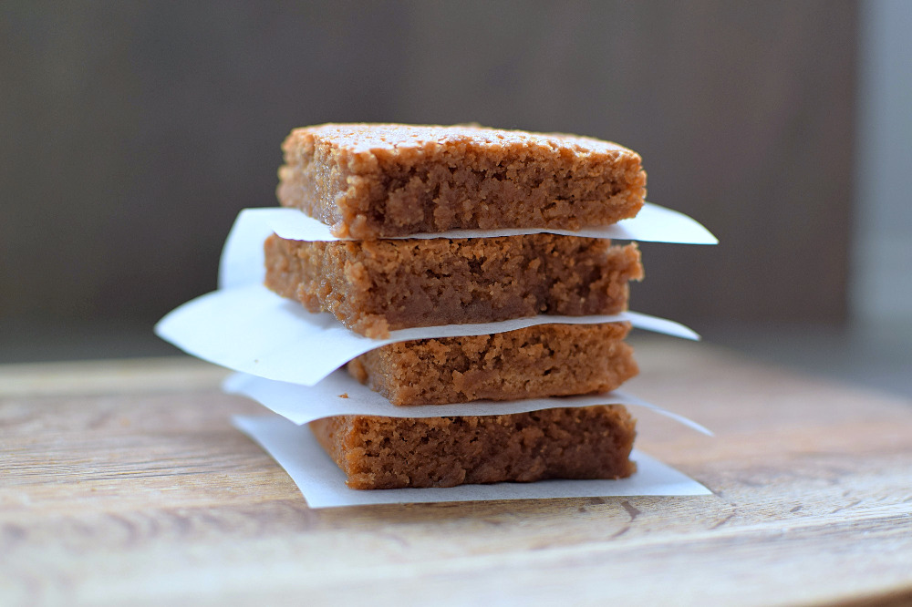 A single stack of blondies with baking papaer in between each one.