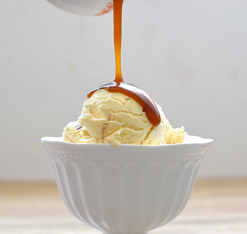Pouring caramel sauce on ice cream