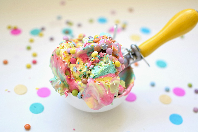 A scoop of ice cream with M&M minis on top.