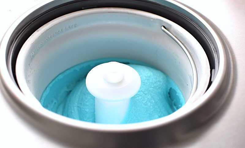 An ice cream maker with churned cookie monster ice cream.