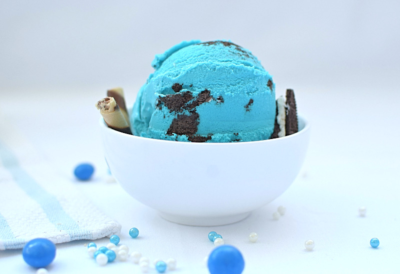 Cookie monster ice cream in a bowl with garnishes.