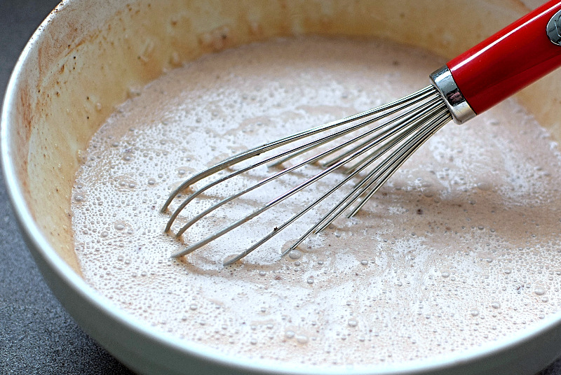Blondie ice cream base in a white bowl with whisk