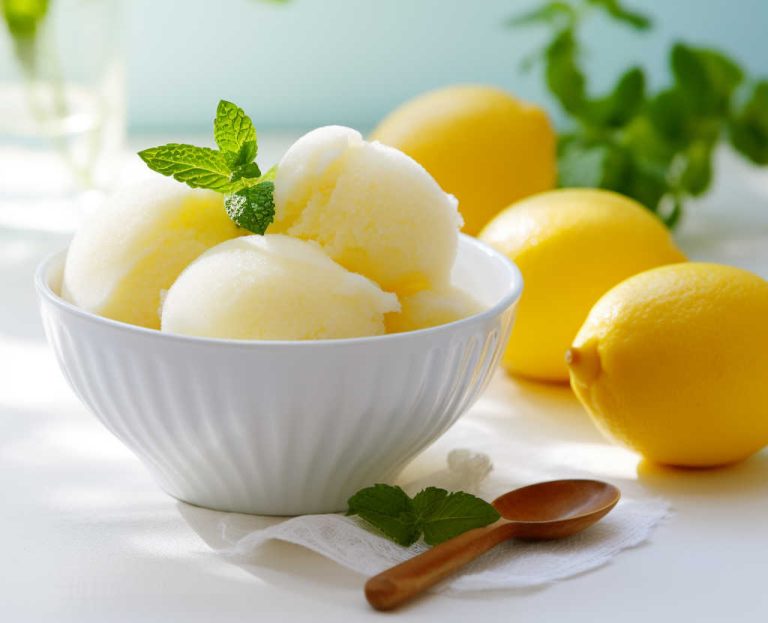 Lemon Sorbet in a white bowl on a kitchen bench.