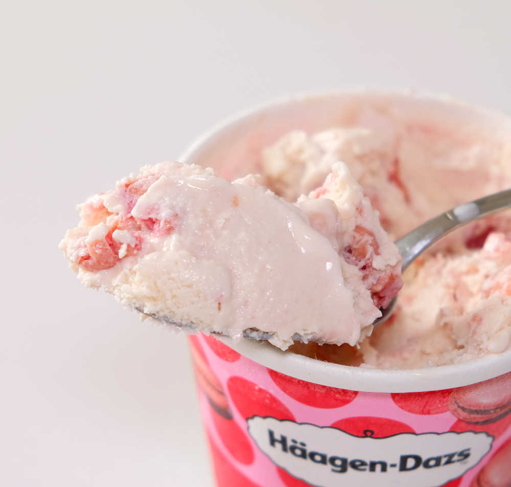 A macro shot of a spoonful of HD ice cream resting on the packaging.