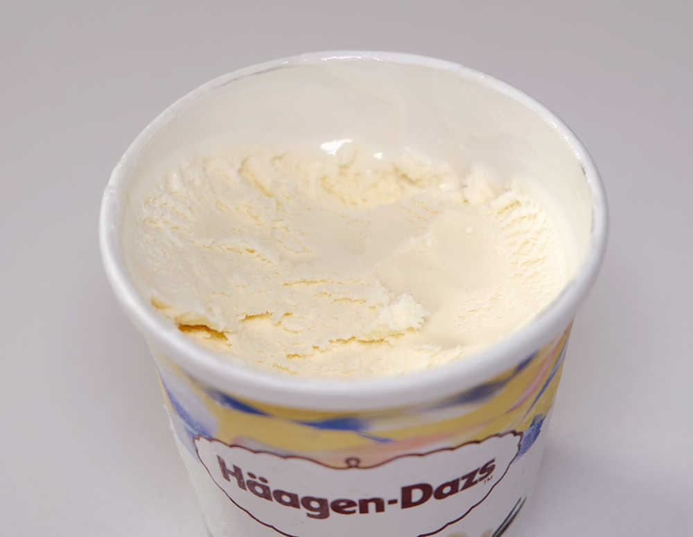 A partly eaten pint of vanilla Haagen Dazs.