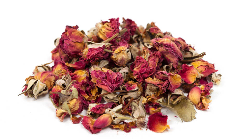 A pile of dried rose petals on white background.