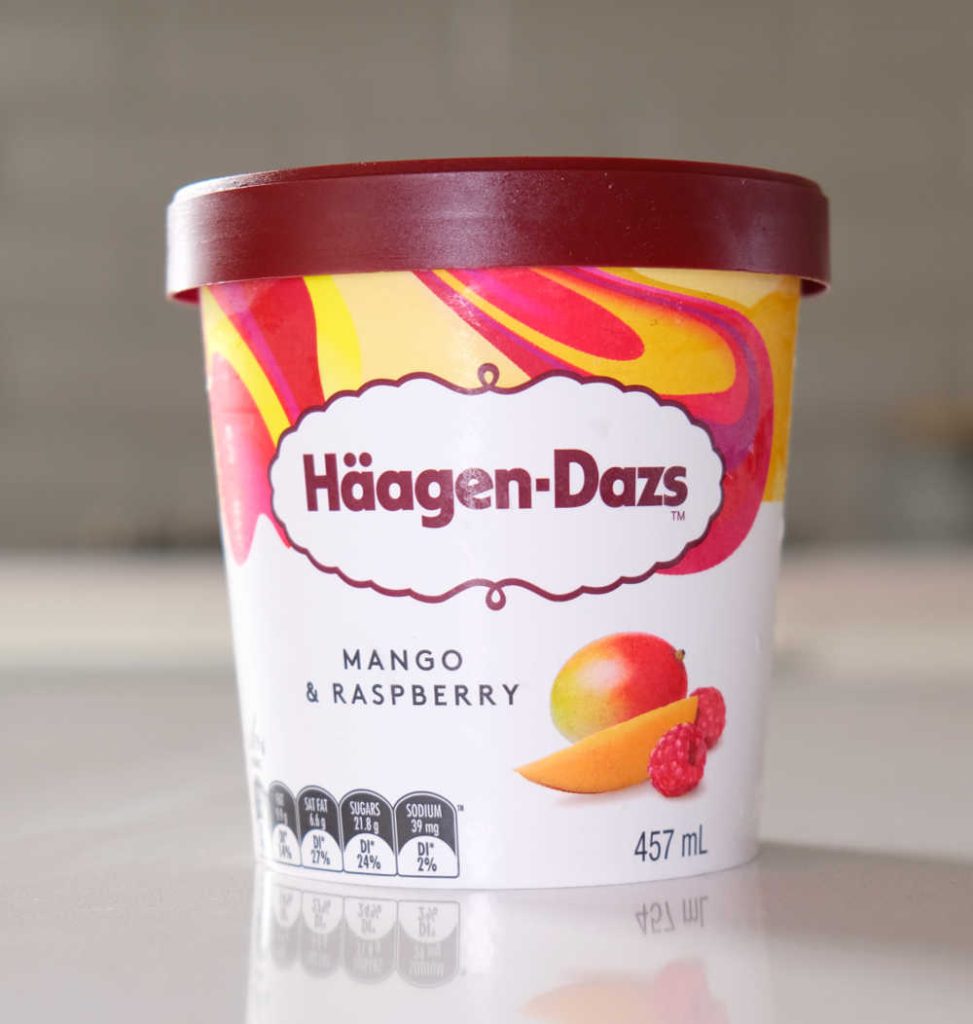 A vertical shot of Mango & Raspberry Dazs Ice Cream.