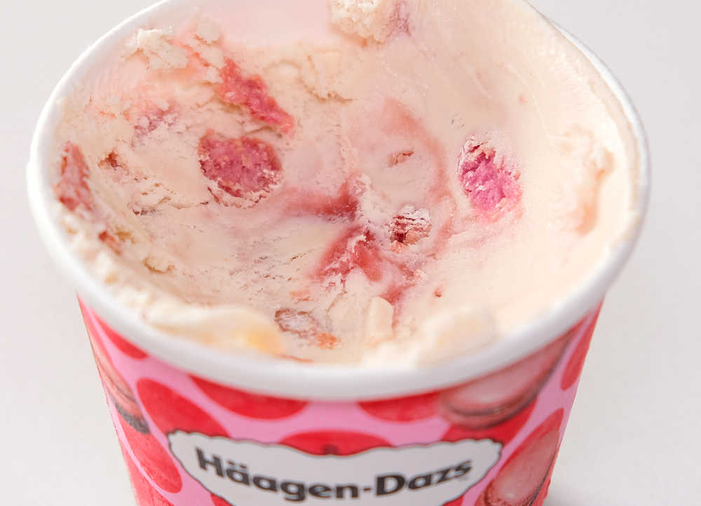 A partly eaten container of HD Strawberry and Raspberry Macaron ice cream.