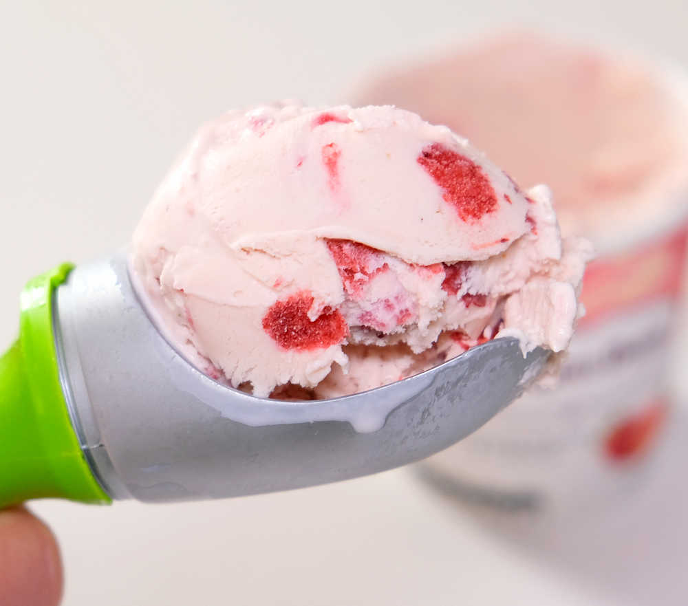 Closeup photo of a scoop of strawberries and cream ice cream by Haagen Dazs.
