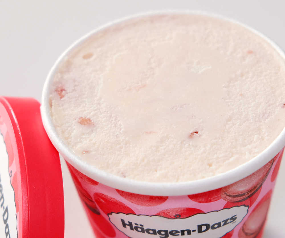 An angled top-down image of unscooped HD Macaron Strawberry Raspberry ice cream.