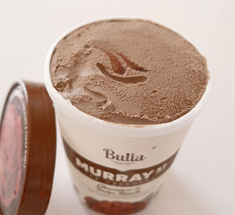 An angled top down shot of an open tub of Murray Street Chocolate Ice Cream