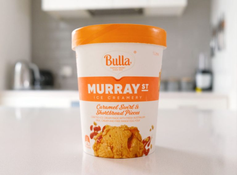 A tub of Murray St Ice Creamery Caramel Swirl and Shortbread Pieces sitting on a kitchen bench