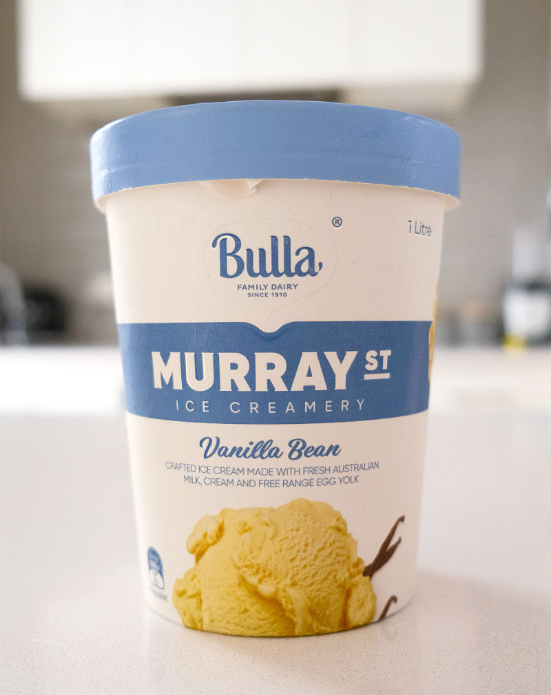 A vertical shot of an unopened pack of vanilla bean ice cream