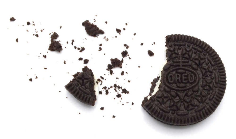 A broken up Oreo cookie on white background.