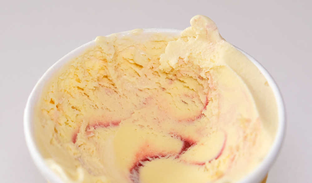 Looking down into a half consumed container of Mango Raspberry ice cream.