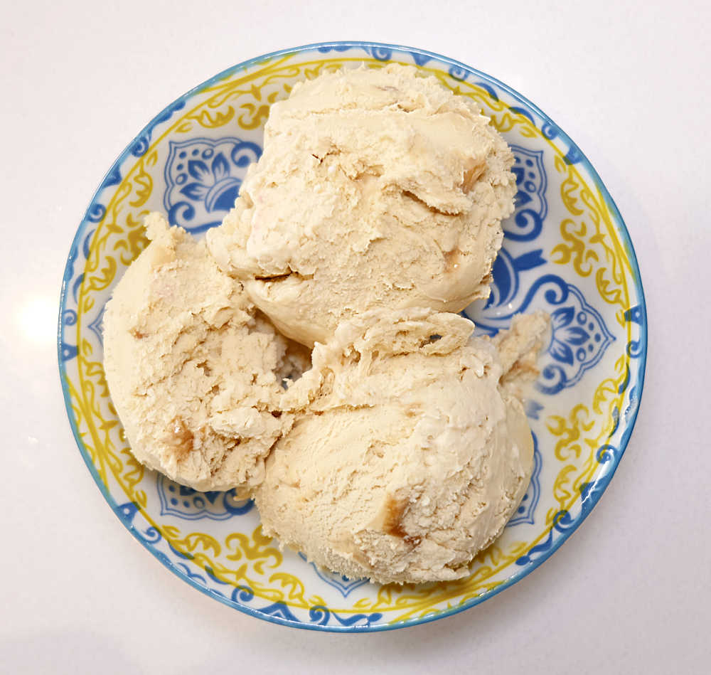 A top-down image of scoops of Salted Caramel Seduction Ice Cream in a bowl.