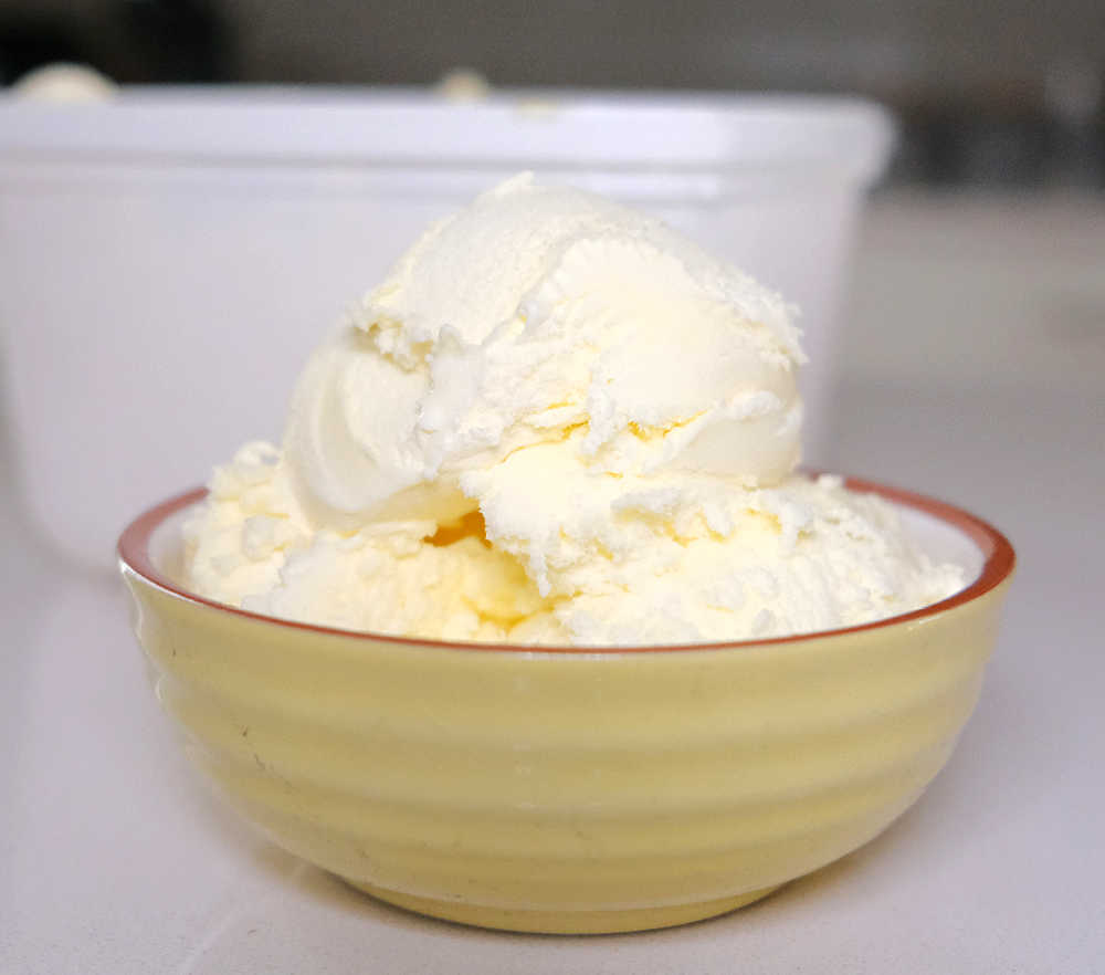 A bowl of Woolworths Van Ice Cream with the container in the background.