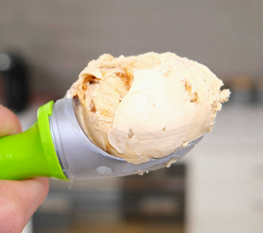 Holing a scoop of Salted Caramel and Cashew ice cream made by Kapiti.