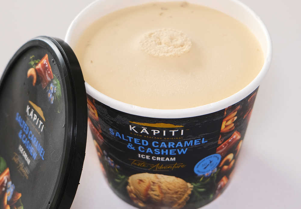 A container of Kapiti Salted Caramel and Cashew with the lid removed and ready to eat.