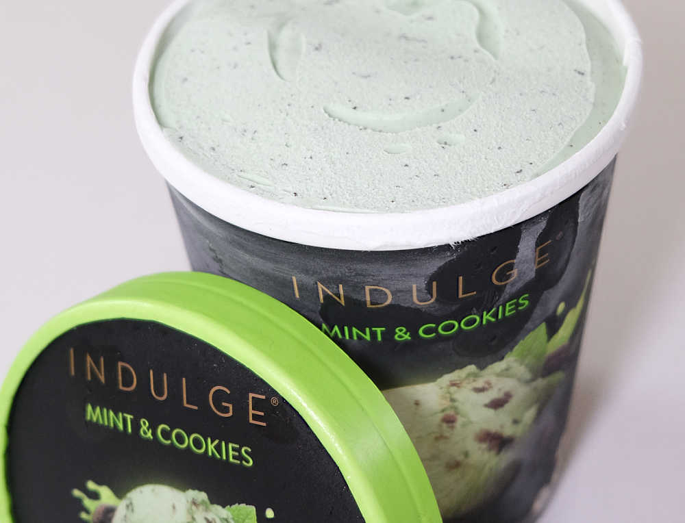 An open pack of Mint Cookie Ice Cream with the lid resting against the side.