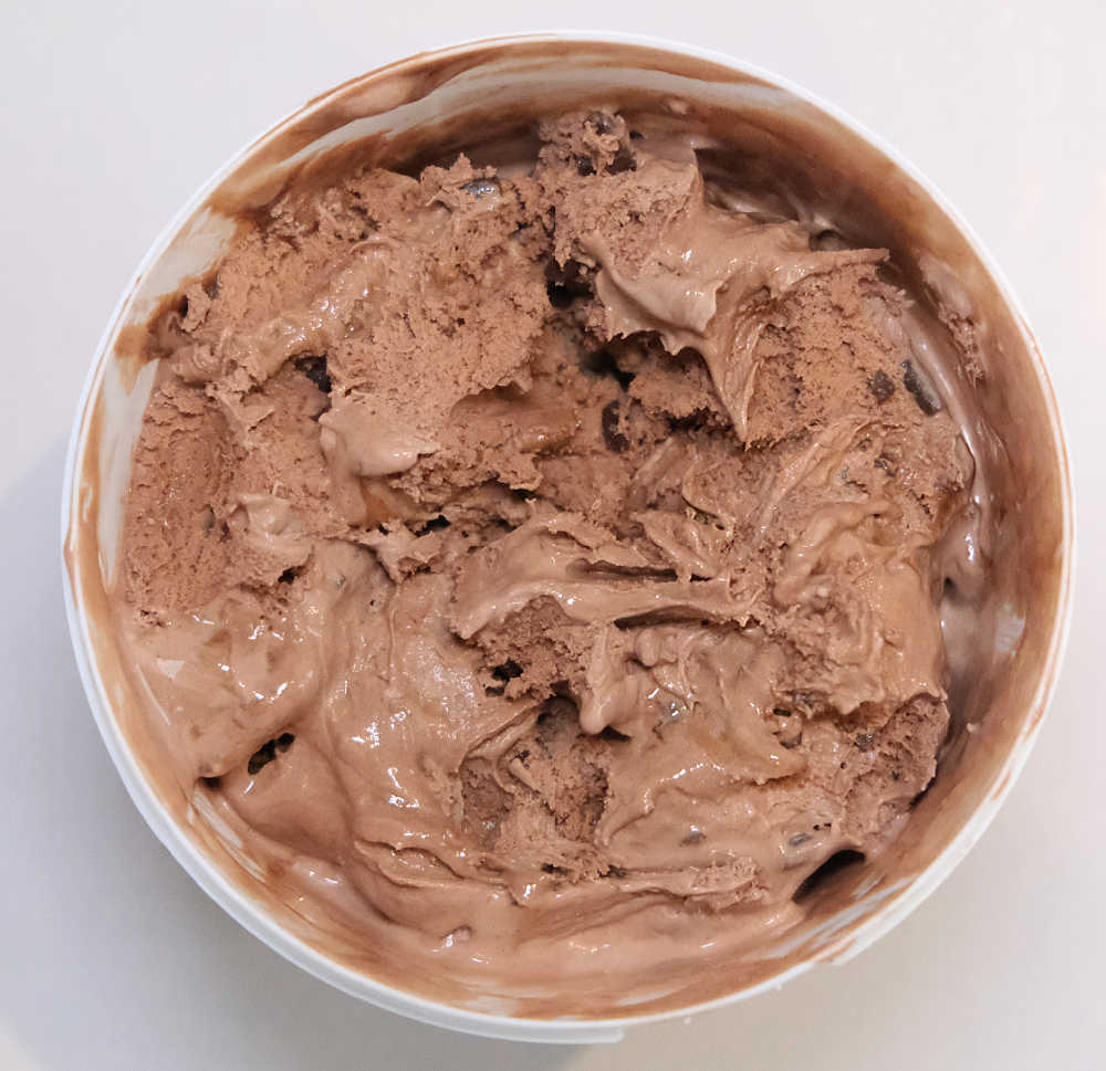 Top down shot of partly eaten Woolworths Choc Ice Cream 1L.