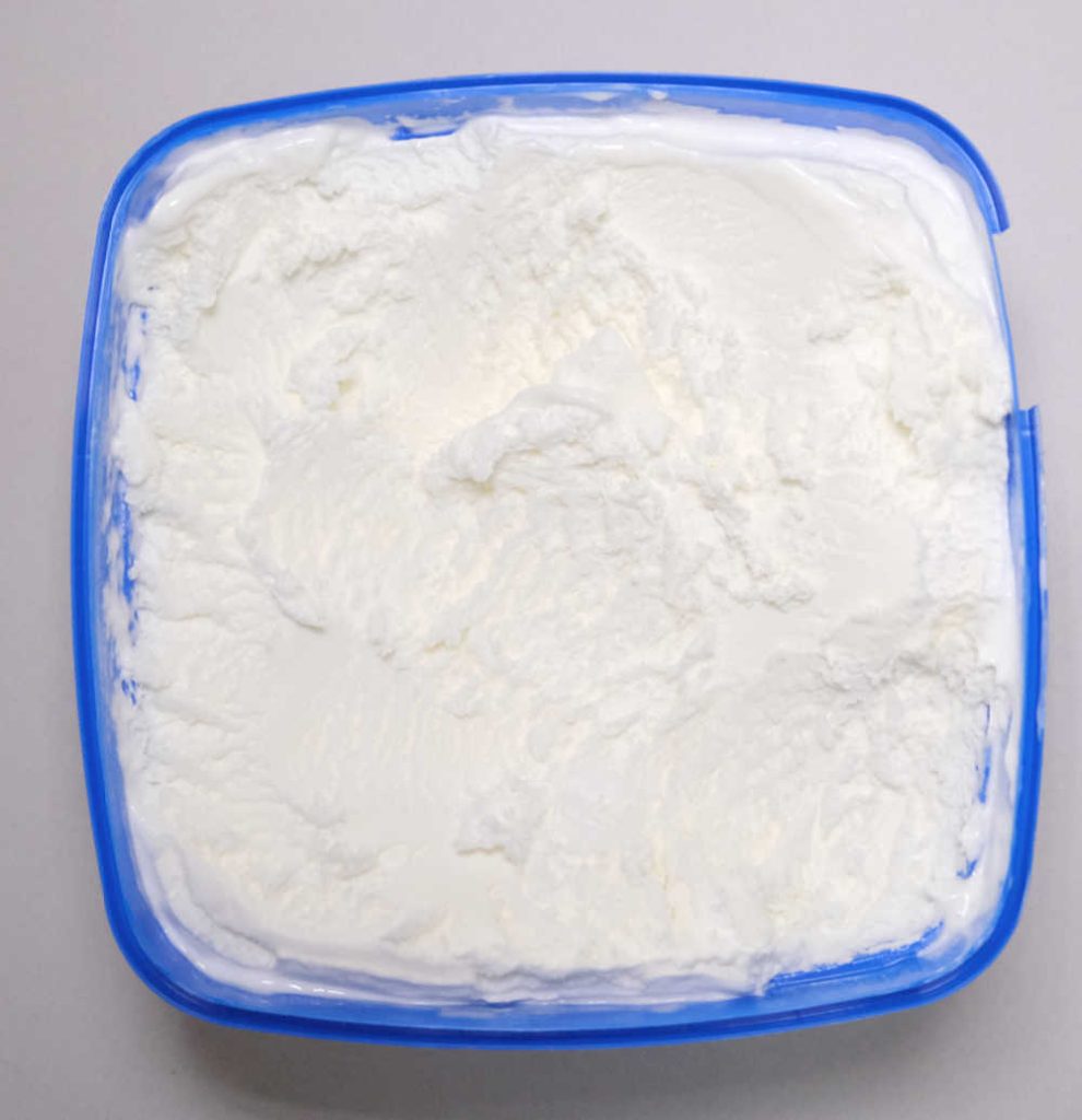 Top-Down image of a partly-eaten container of Peters Original Vanilla.