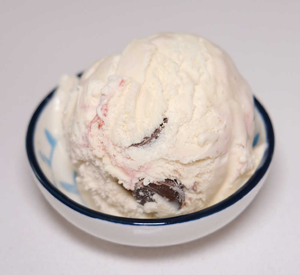 An isolated bowl of Peanut Butter Cup Raspberry Ripple.