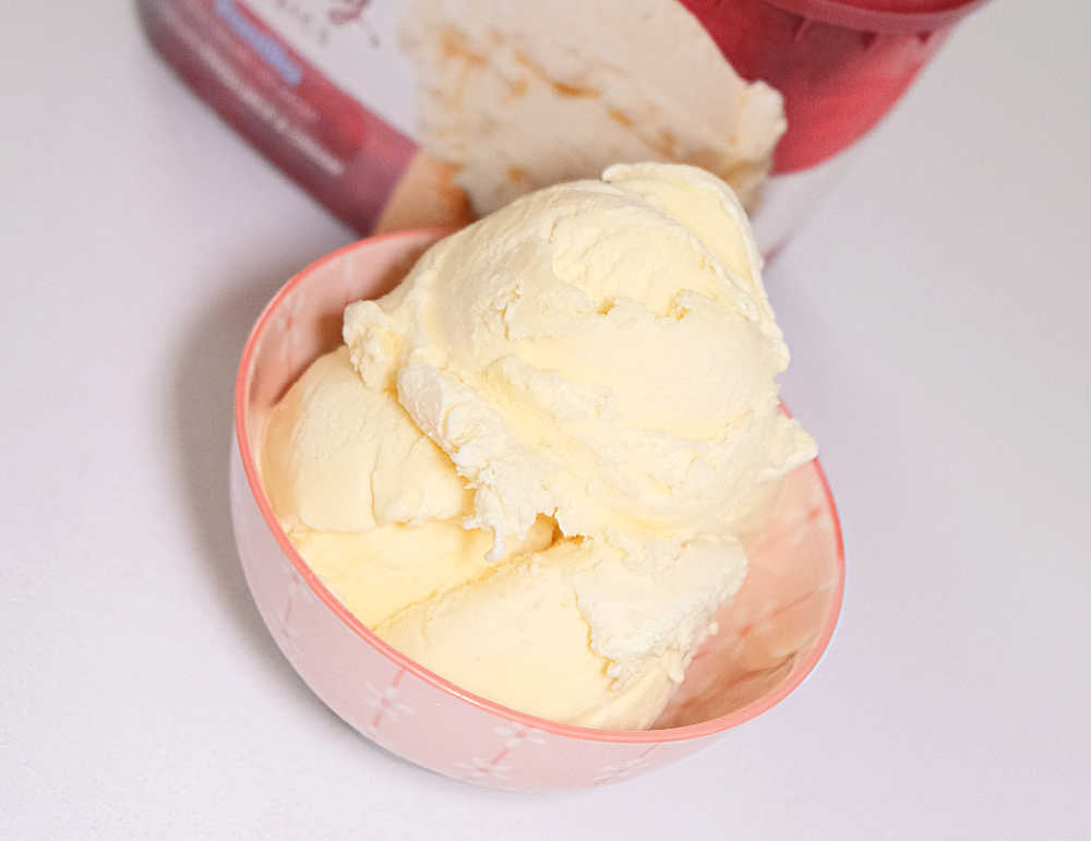 Scoops of vanilla ice cream in a bowl.