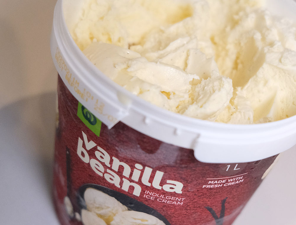 A macro shot of the Woolworths Vanilla Tub partly eaten.