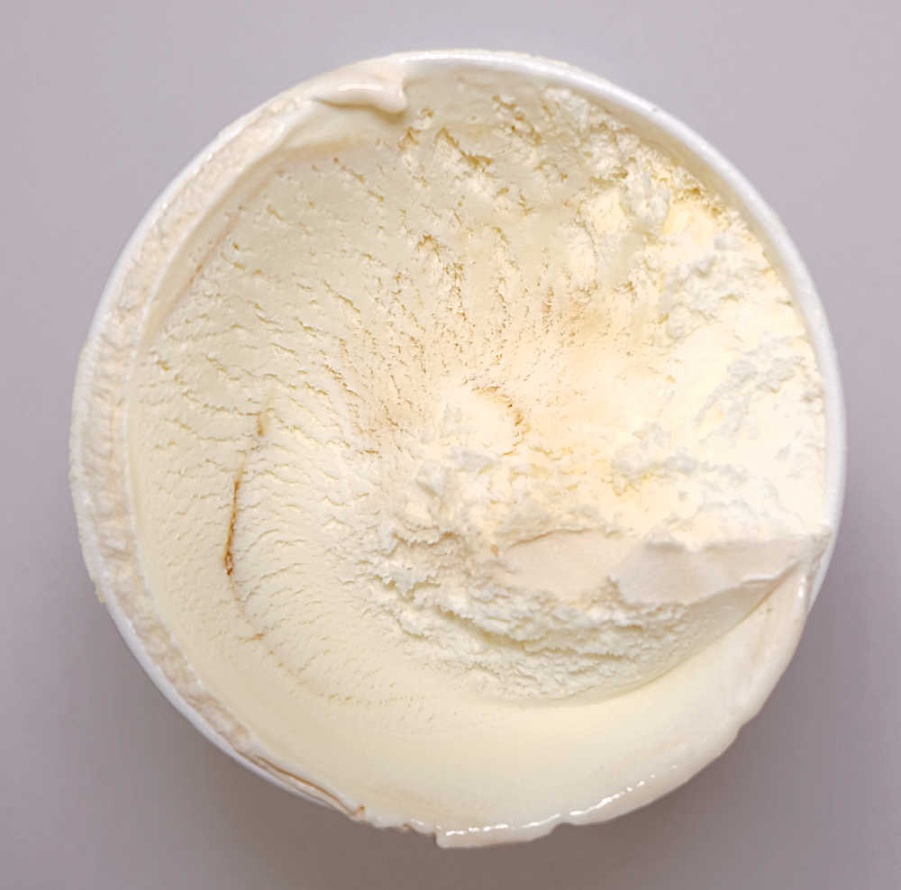 A partly eaten pack of Caramel Ice Cream by Coles.