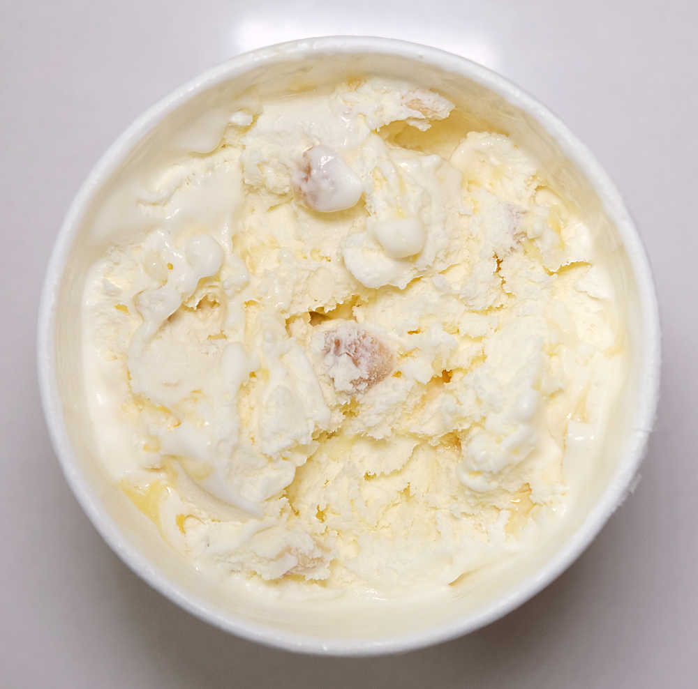 Top down photo showing the texture of the White Choc Macadamia Mango Ripple Ice Cream.