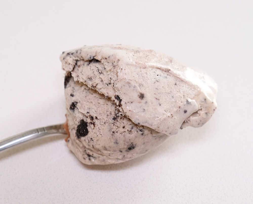 Closeup of a spoonful of cookies ice cream from a pack of Much Moore Family Classic.