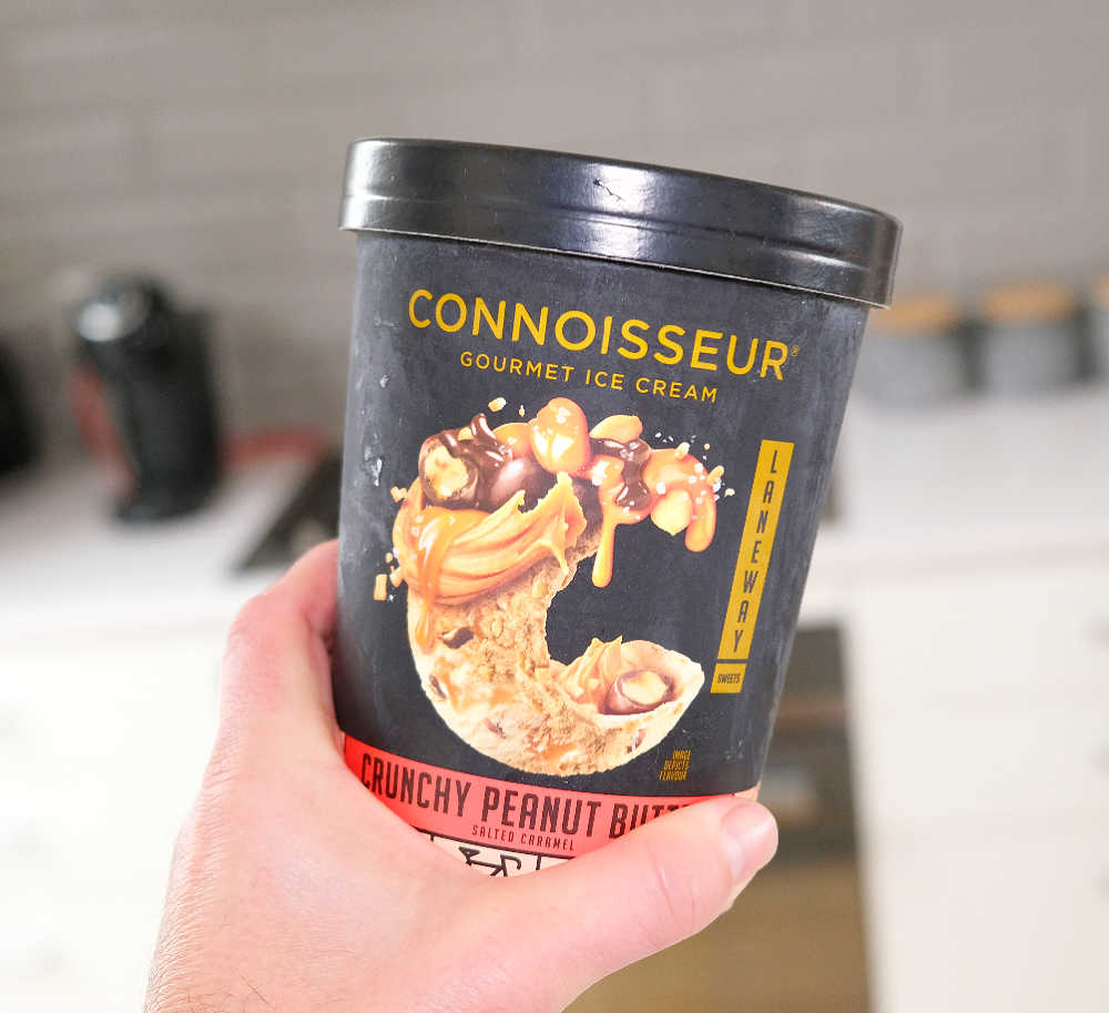 Holding a tub of Crunchy Peanut Butter Ice Cream by Connoisseur.