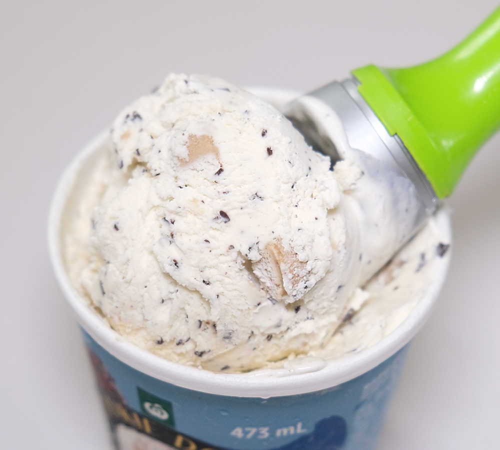 Closeup of a scoop of Woolworths Cookie Dough Choc Flakes Ice Cream.