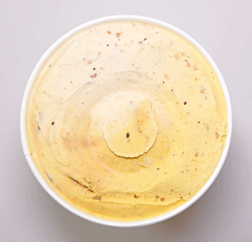 Top down image of an unscooped container of Connoisseur Choc Chip Cookie Ice Cream.