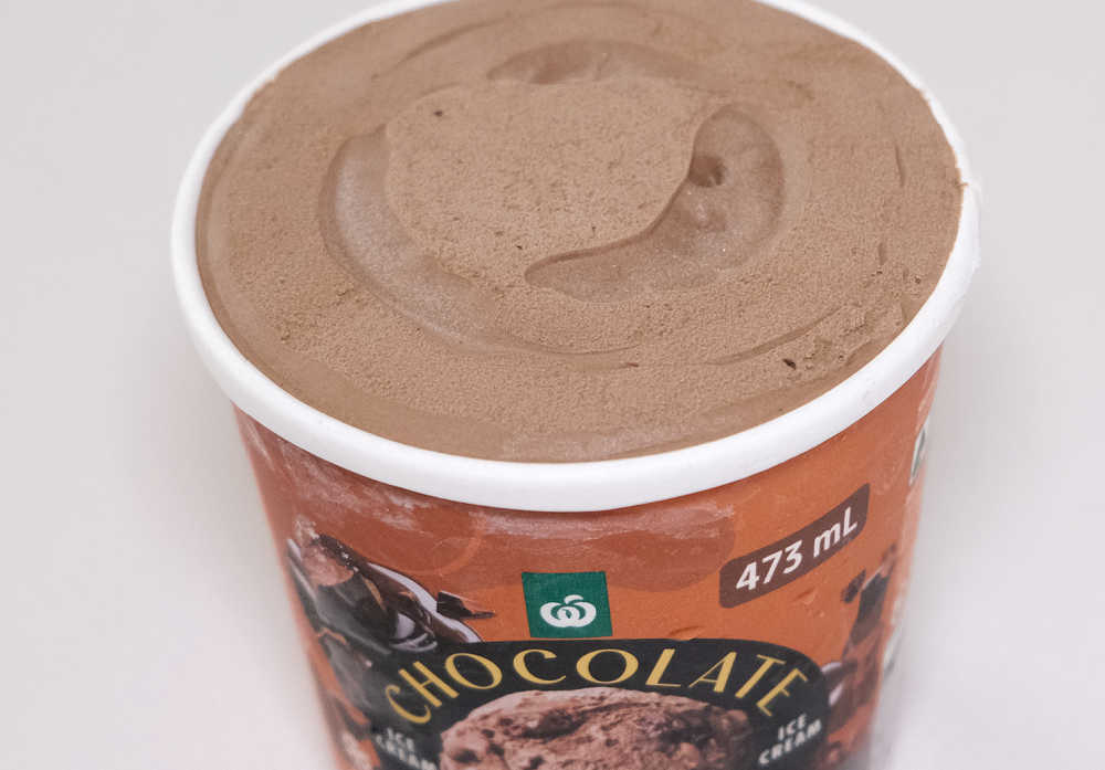 An unscooped container of WOW Chocolate Brownie 473ml.