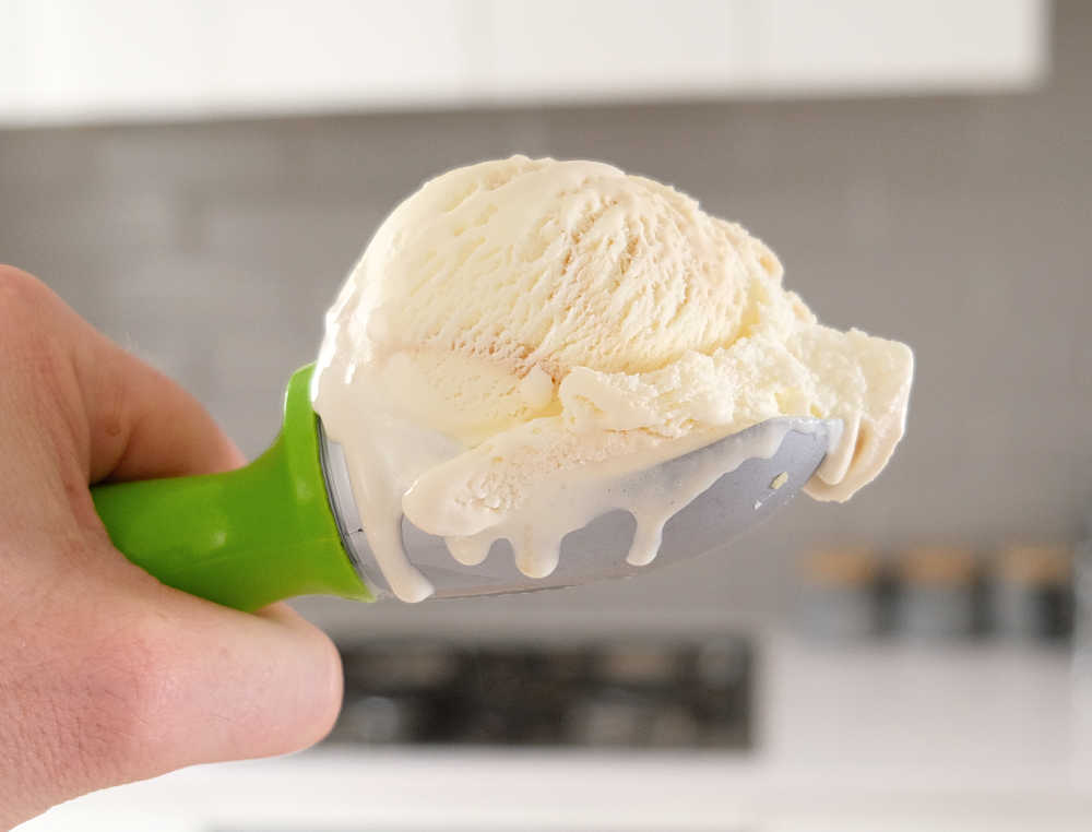 Holding a scoop of salted caramel ice cream.