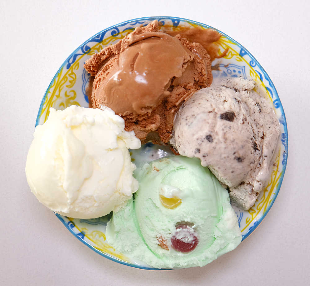 A bird's eye view of a bowl containing the four flavour variants from a tub of Much Moore Family Classic.