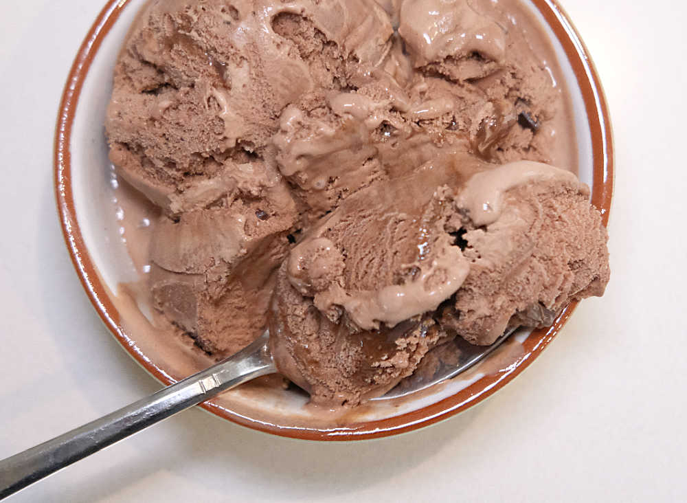 A bird's eye view of a dish with scoops of triple choc ice cream.