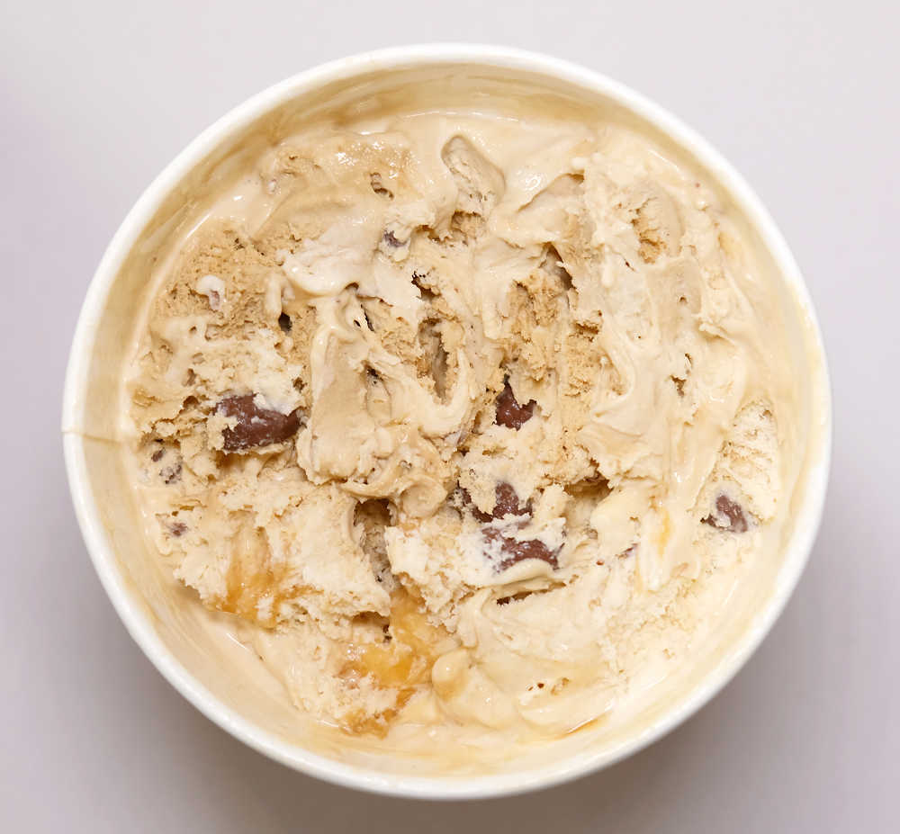 Top-down photo of a partially eaten tub of Connoisseur Peanut Butter Ice Cream.