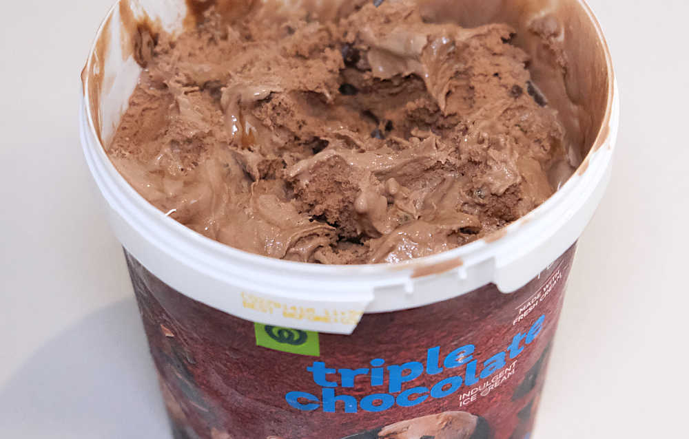 A closeup of an opened tub that has been partly eaten.