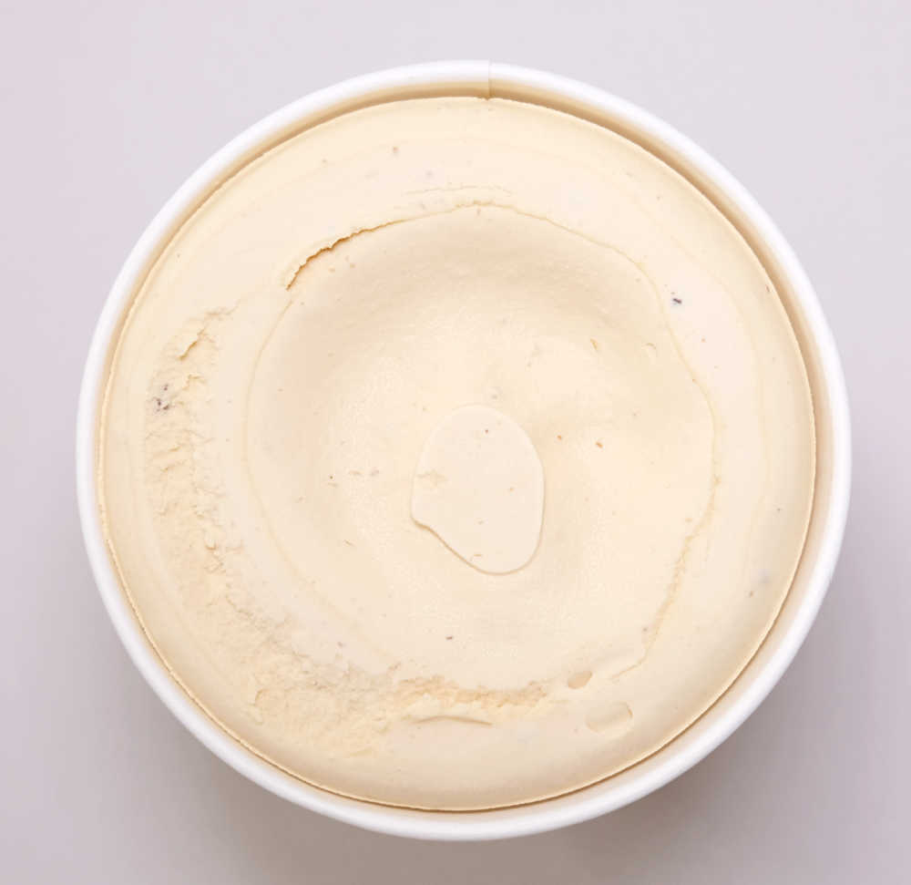 An un-scooped pack of Coles Rum and Raisin Ice Cream.