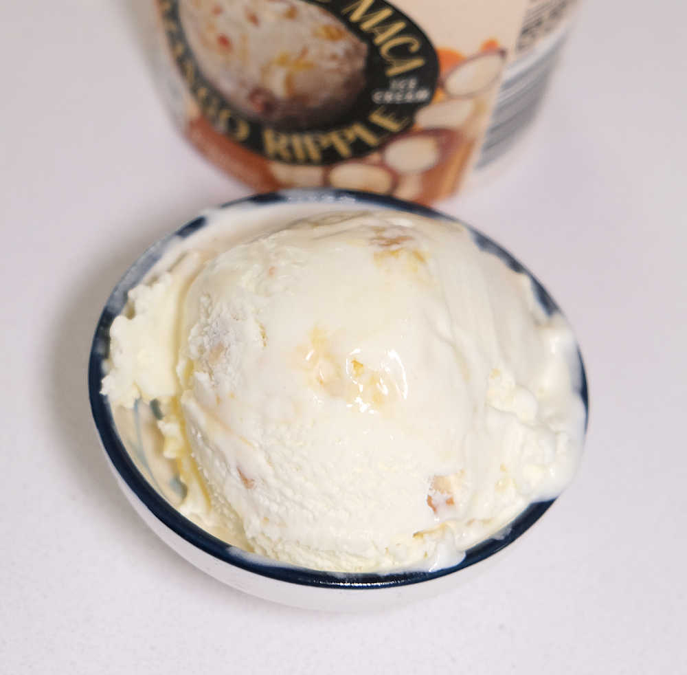 Whit Choc and Macadamia frozen dessert in a bowl on a white counter.