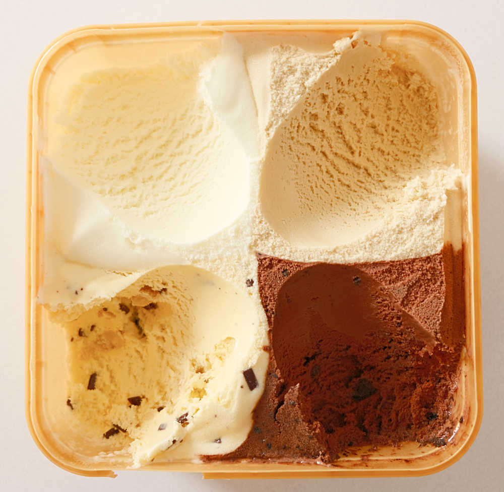 A bird's eye view of the partly scooped Much Moore Awesome Cravings Ice Cream tub.