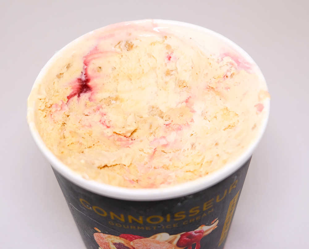 An angled top-down photo of Connoisseur Ice Cream, Jam Doughnut.