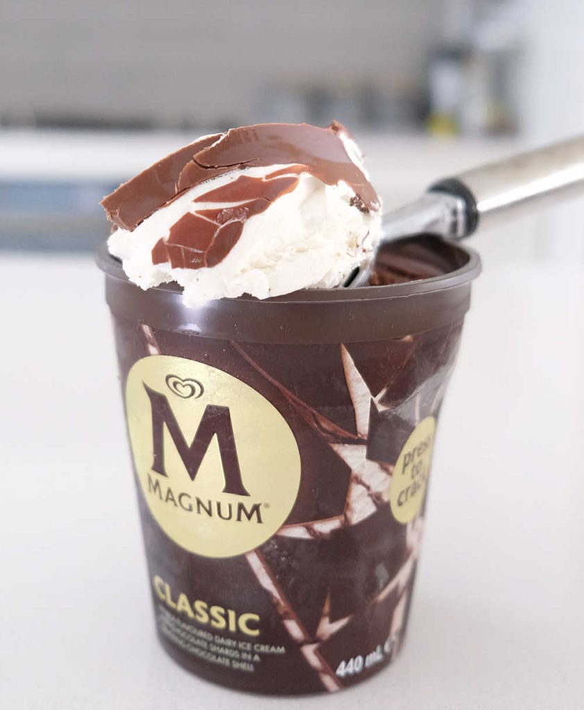 Closeup of a scoop of Magnum Classic sitting on the top of the tub.