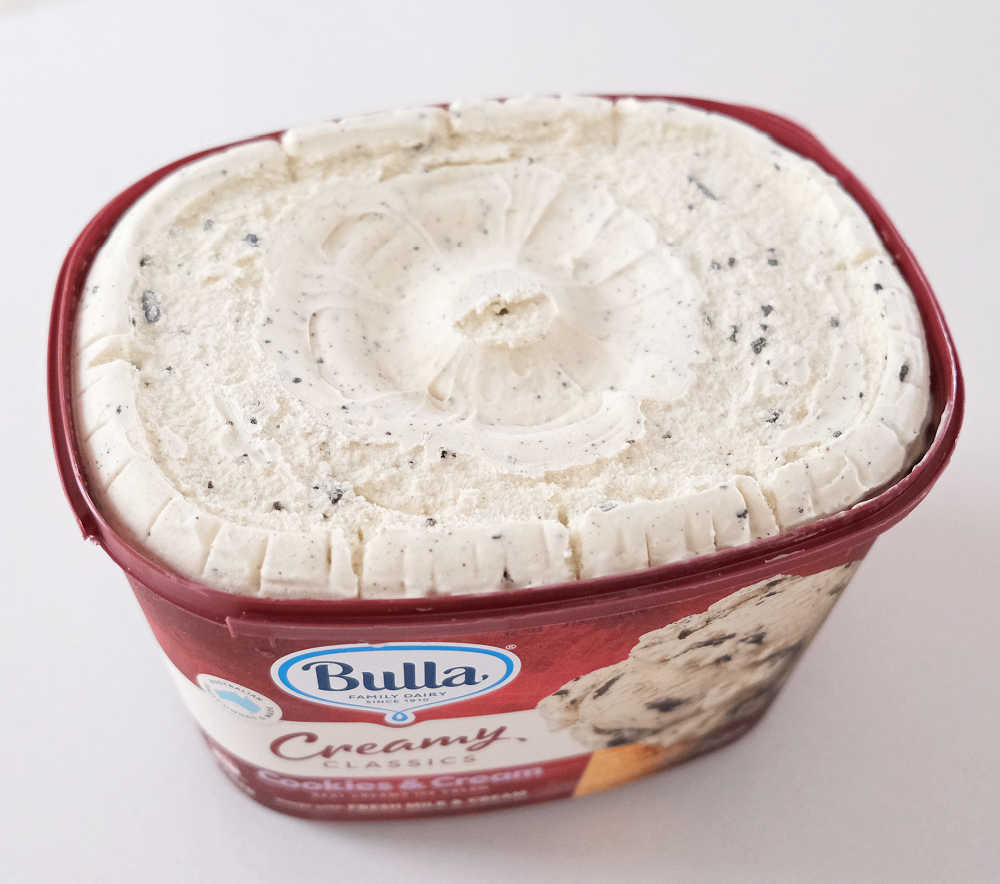 An unscooped pack of Cookies & Cream ice cream, Creamy Classics.