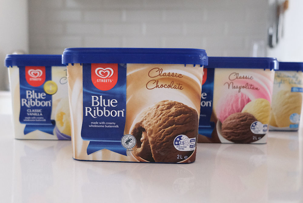 A line of Blue Ribbon 2L tubs on a kitchen bench.